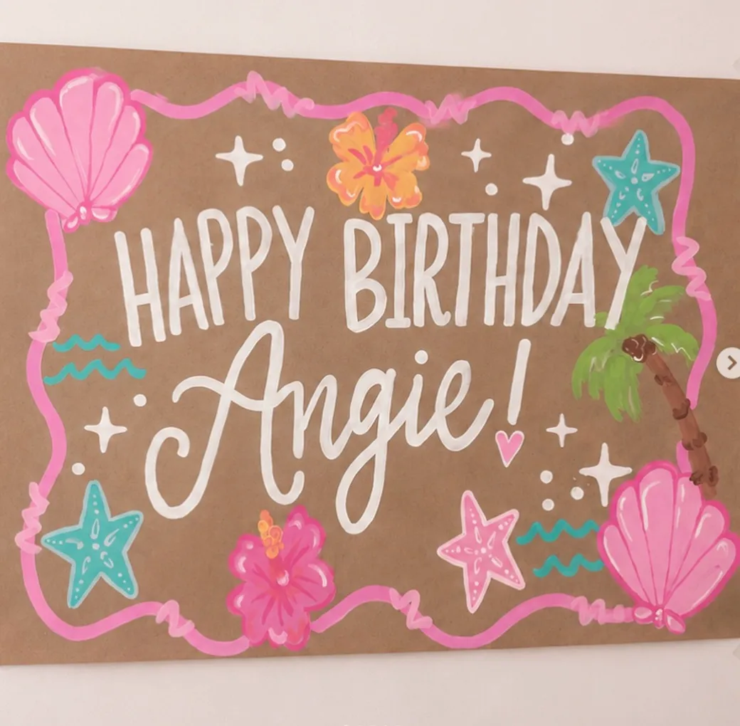 Tropical happy birthday banner with seashells, starfish, and a palm tree