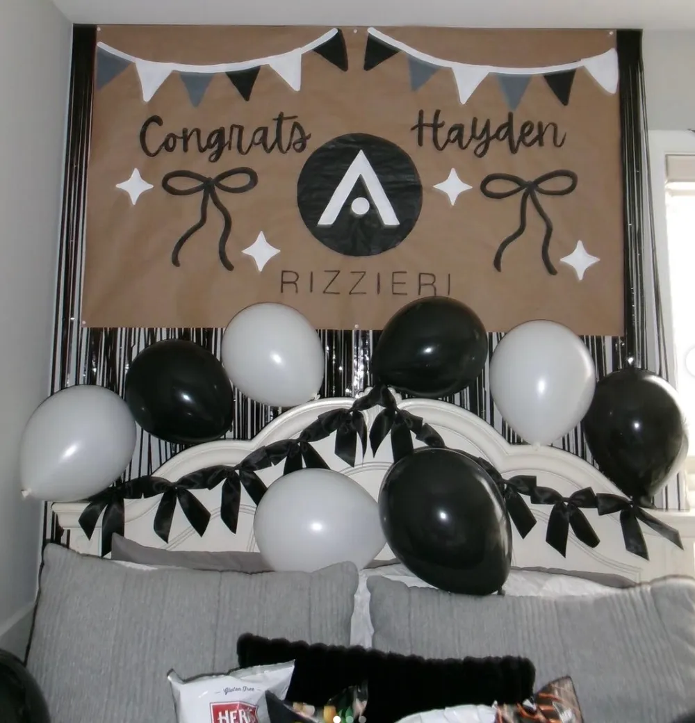 Black and white congratulations banner with pennant flags and painted bows
